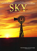 Sky Magazine cover with an old-fashioned windmill on a prairie at sunrise or sunset creating an amber sky streaked with gold and brown clouds.