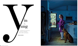 Magazine spread, 'Yin & Yang: A Daring second act for Neil Kremer and Cory Johnson by Eric Minton' on left page, cartoon-like photo of a woman in pagjamas and robe looking into an opened refrigerator with a dog sitting by her side, the only light in the image coming from the opened refrigerator.
